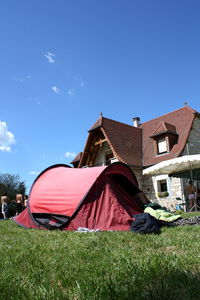 Built structure on field against blue sky