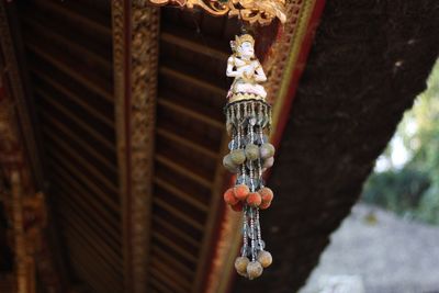 Low angle view of decoration hanging on ceiling at temple