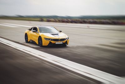 Yellow toy car on road