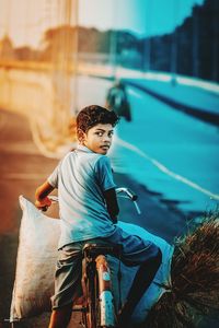 Rear view of boy looking at camera