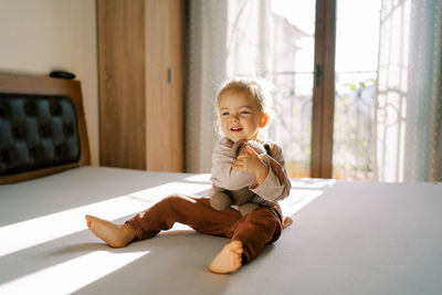 Portrait of boy sitting on table