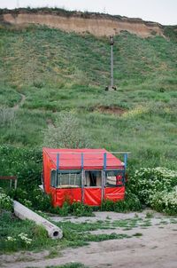 Red cart on field by road