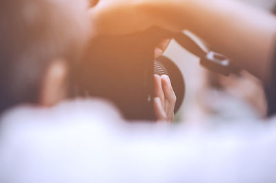 Cropped image of man photographing with camera