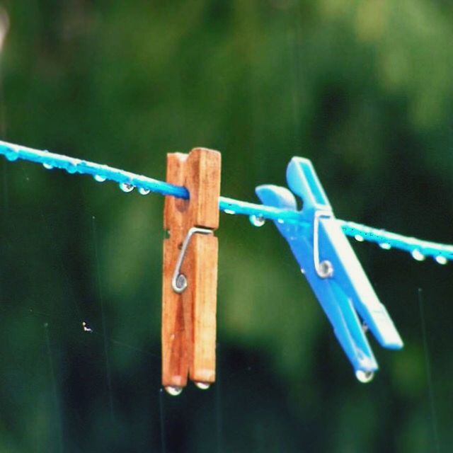 focus on foreground, close-up, blue, metal, safety, fence, protection, wood - material, selective focus, security, clothespin, hanging, day, rusty, rope, outdoors, no people, clothesline, green color, wooden post