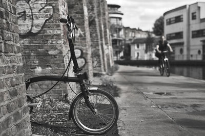 Bicycle on footpath against building