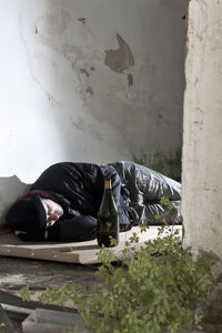 Man sleeping on wall