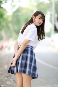 Portrait of young woman standing outdoors