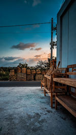 Gazebo by building against sky during sunset