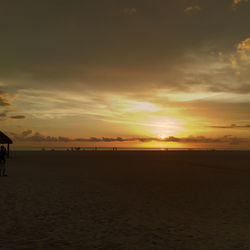 Scenic view of beach against sky during sunset