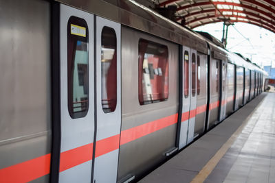 Delhi metro train arriving at jhandewalan metro station in new delhi, india,asia, public metro train