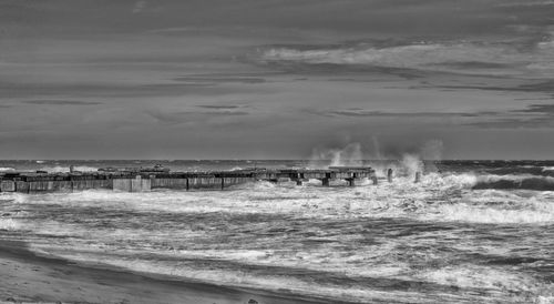 Scenic view of sea against cloudy sky