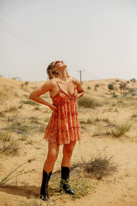 Full length of woman standing at desert