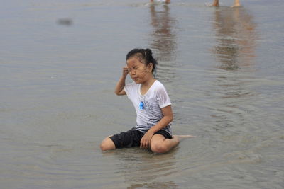 Portrait of young woman standing at beach