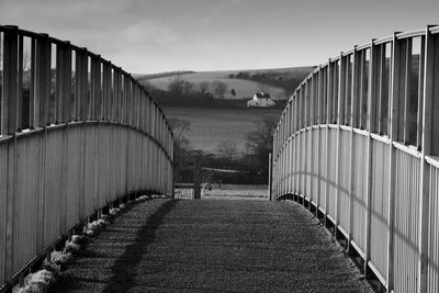 View of footpath on field against sky