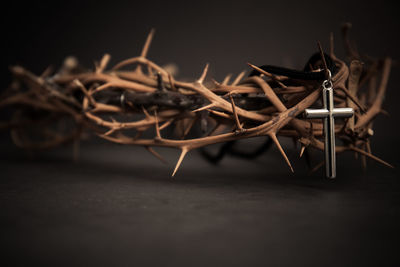 A cross with thorn crown with dark background with copy space. 