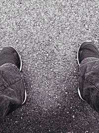 Low section of person standing on road