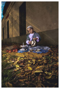 Portrait of young woman sitting on field