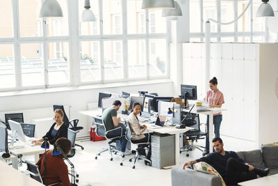 High angle view of multi-ethnic business people working in modern office