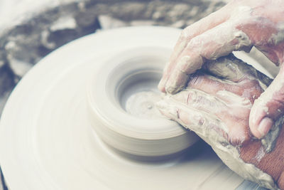 Close-up of person hand in mud