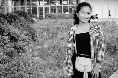 Portrait of smiling woman standing outdoors