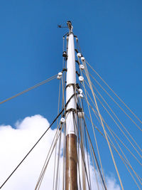 Low angle view of sailboat against clear blue sky