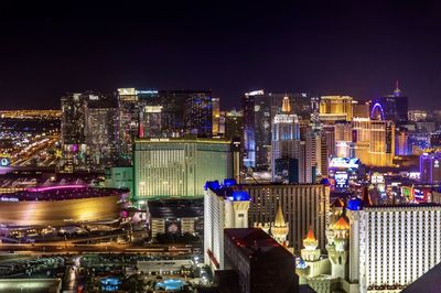 High angle view of illuminated city buildings at night