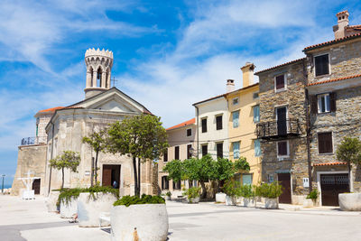 Exterior of buildings in town against sky