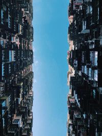 Low angle view of buildings against blue sky