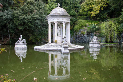 Statue in park by lake