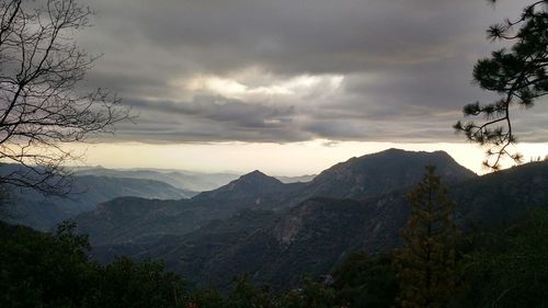 Scenic view of mountains against cloudy sky