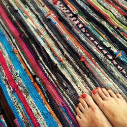 Low section of woman on colorful carpet