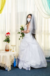 Woman wearing mask against white background