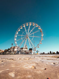 Ferris wheel against clear blue sky