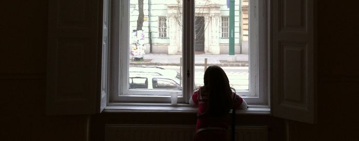 Woman standing by window