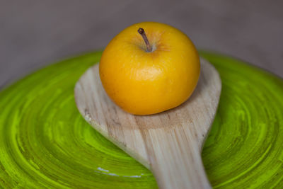 Golden delicious apple on wooden spatula