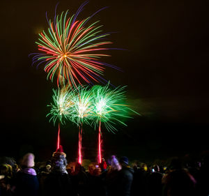 Low angle view of firework display at night