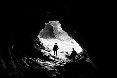 Silhouette of man in cave