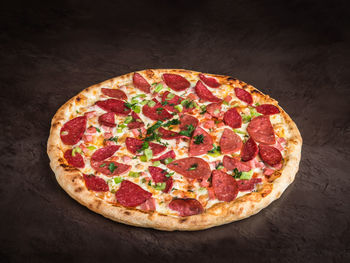 High angle view of pizza on table against black background