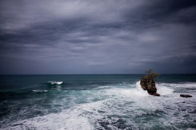 Scenic view of sea against storm clouds