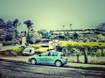 Cars on road against clear sky