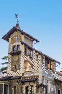Low angle view of old building against clear blue sky