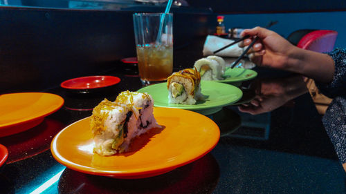 Close-up of person eating food in restaurant