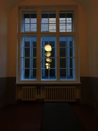 Reflection of building on glass window at night