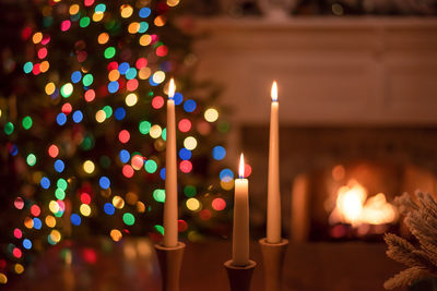 Close-up of illuminated candles against blurred background