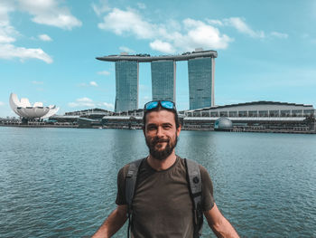 Portrait of smiling man against marina bay sands in city