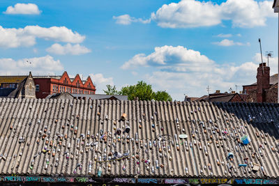 Cans on roof against cloudy sky