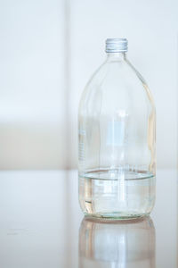 Close-up of glass bottle on table