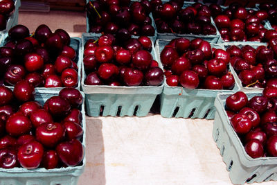 High angle view of cherries in crates at market