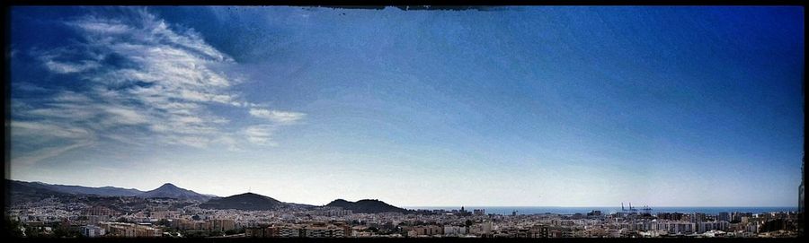 View of cityscape against blue sky