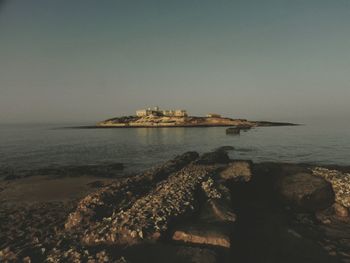 View of sea with rocks in background